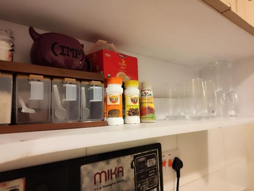 RungiriにあるGoodlife Apartmentのキッチン棚(ボトル、グラス付)