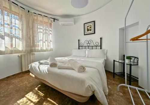 a white bedroom with a large bed with white sheets at Villa Maréa Private Luxury Villa in Santa Faz
