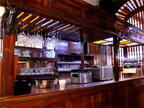 a bar with a counter with glasses on it at Hotel Frances in Guadalajara