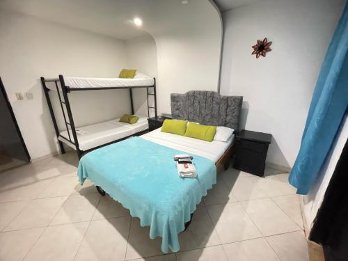 a small room with a bed and a chair at Hotel Boutique San Sara Santa Marta Terminal in Santa Marta
