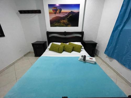 a bedroom with a bed with a phone on it at Hotel Boutique San Sara Santa Marta Terminal in Santa Marta