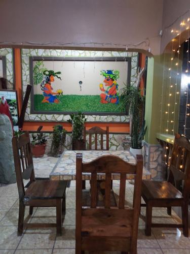 a dining room with a table and two chairs at Hotel La Escalinata in Copan Ruinas
