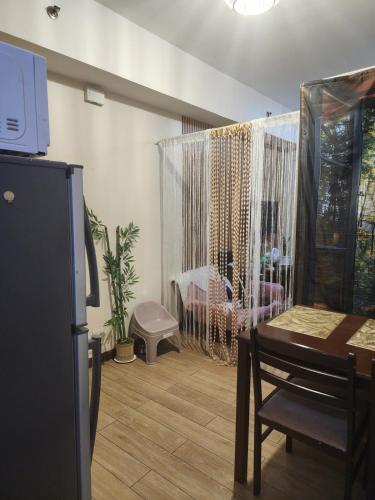a dining room with a table and a room with a window at Condotel Near NAIA - massage chair footspa, dance revo, small pet allowed in Manila