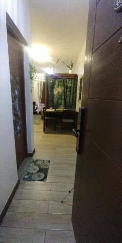 a hallway with a living room with a couch at Condotel Near NAIA - massage chair footspa, dance revo, small pet allowed in Manila