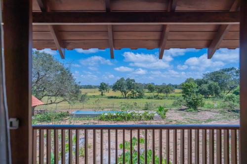 a view from a window of a garden at Tranquil Trails Sigiriya in Dambulla