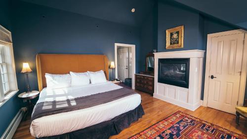 a bedroom with a large bed and a television at Butter milk falls inn in Milton