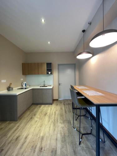 an open kitchen and dining room with a table at Aeropod Sovo for 5 pax in Kota Kinabalu