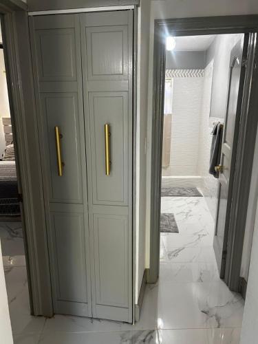a bathroom with a white cabinet with two handles at Cane Garden Bay 2 bed Apt in Leonards