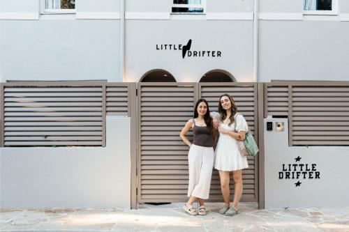 two women standing in front of a building at Little Drifter Bondi in Sydney