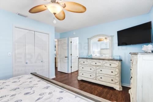 a bedroom with a dresser and a flat screen tv at 2706 W, 3rd St home in Fernandina Beach