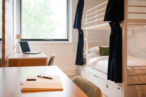 a room with a desk and a bunk bed at Little Drifter North Melbourne in Melbourne