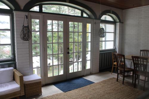 a living room with french doors and windows at The Master Bedroom at the Hillside B&B in Wisconsin Dells