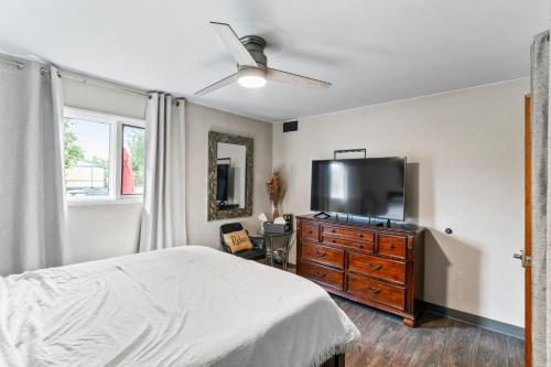 a bedroom with a bed and a flat screen tv at KING SUITE ON 16TH AVE in Anchorage