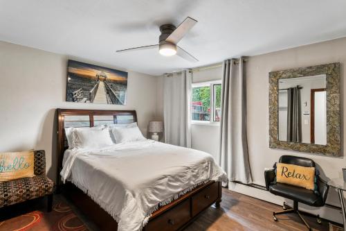 a bedroom with a bed and a fan and a chair at KING SUITE ON 16TH AVE in Anchorage
