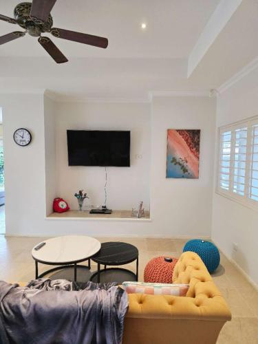 a living room with a couch and a table at Spacious Serene Luxury Retreat in Narre Warren South