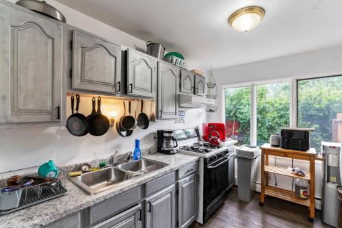 a kitchen with a sink and a stove top oven at KING SUITE ON 16TH AVE in Anchorage