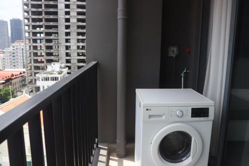 a washing machine on a balcony with a city at Parc21 Luxury Boutique Hotel in Phnom Penh