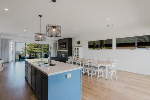 a kitchen and living room with a table and chairs at The Dual Family Entertainer 9 Esplanade Victor Harbor - Linen Included - Luxury - Seafront in Victor Harbor