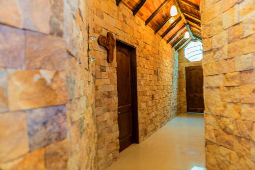 an empty hallway with a door in a brick wall at Hotel San Bada Resort & Spa in Manuel Antonio