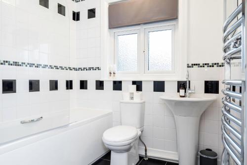 a white bathroom with a toilet and a sink at Luccombe Lodge in Southampton