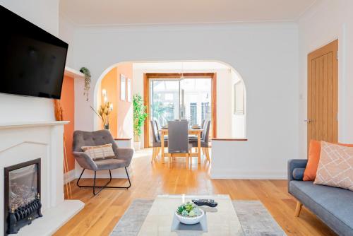 a living room with a fireplace and a table at Luccombe Lodge in Southampton