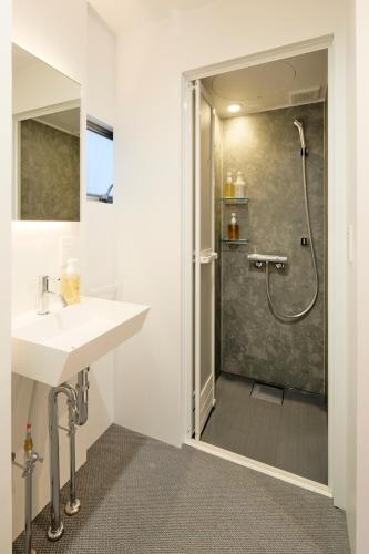 a bathroom with a sink and a shower at SHORTsuido in Tokyo