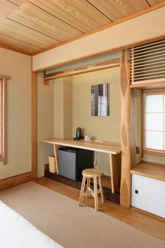 a room with a desk and a bed and a table at SHORTsuido in Tokyo
