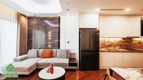 a living room with a couch and a kitchen at Thuý Doji Diamond Apartment in Hai Phong
