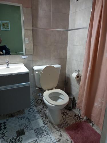 a bathroom with a white toilet and a sink at Departamento Monoambiente Centro Villa Carlos Paz in Villa Carlos Paz