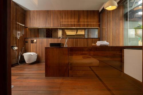 a bathroom with a sink and a toilet at Hoshi Hotel Hatyai in Hat Yai