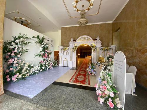 a room with flowers on the walls and a corridor at An Thái Hotel in Kon Tum