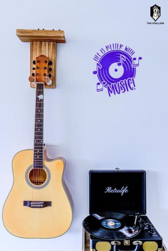 a guitar on a stand next to a music box at The Stallion #108 - Modern Spacious Loft in Downtown with free parking in Memphis
