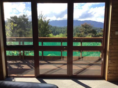 a view from a window looking out at the mountains at Kaiteriteri Affordable Luxury Somehing Special in Kaiteriteri