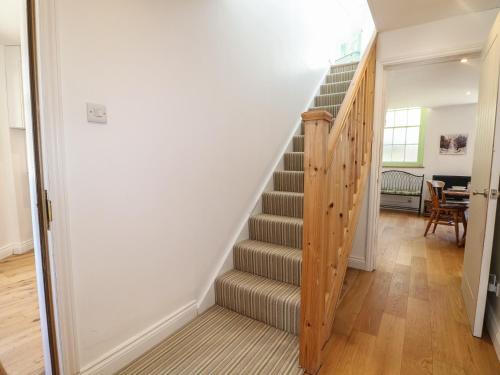 a staircase in a home with wooden floors at Middle Tower in Betchworth