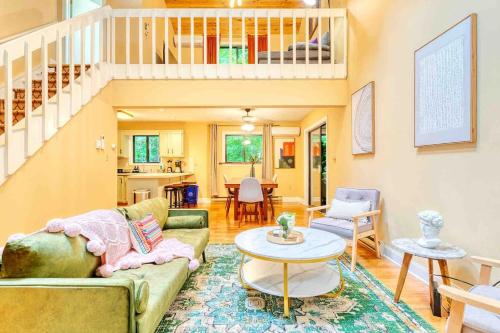 a living room with a couch and a table at Grand Woodland Retreat - Hot Tub - Game Room in Gouldsboro