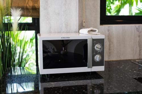 a microwave sitting on top of a table at Baan Chom View Kamala - SHA Plus in Kamala Beach