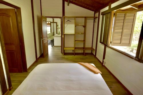 a large bed in a room with a window at Villa Jimi Las Terrenas in El Naranjito
