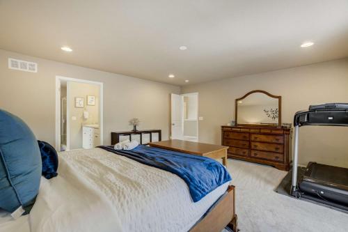 a bedroom with a bed and a dresser and a mirror at Clear Estate Spacious Retreat with BBQ & Views in Pikeview