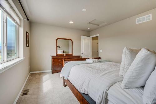 a bedroom with a bed and a dresser and a mirror at Clear Estate Spacious Retreat with BBQ & Views in Pikeview