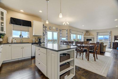 a kitchen with white cabinets and a dining room with a table at Clear View Scenic Retreat w Work-Friendly Spaces in Pikeview