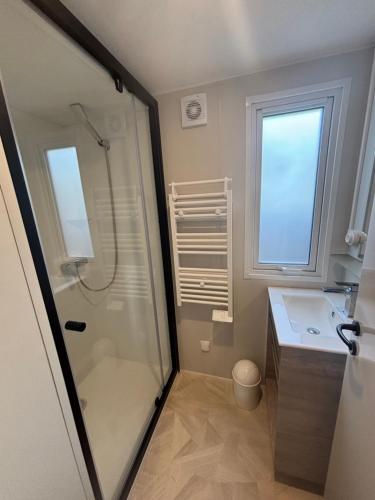a bathroom with a shower and a sink at Domaine MON CALME in Piriac-sur-Mer