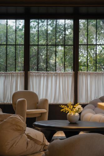 a room with a table and chairs and windows at BuYuan Hotel - Near Wuhou Shrine, Chunxi Road,T aikooli, Tianfu Square, People's Park, Chengdu Museum, Very close to the Sichuan University , Exit C of Huaxiba on Metro Line 1,Provides Welcome refreshments ,Minibar,Laundry & Luggage delivery service in Chengdu