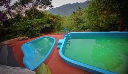 a swimming pool with a tub on top of a house at The Hillock-quiet by the Mountains in Vallikavungal