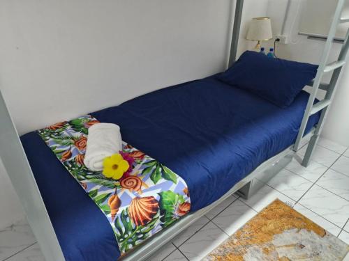 - un lit avec une couette bleue et des serviettes dans l'établissement JetPoint Family Home, à Nadi