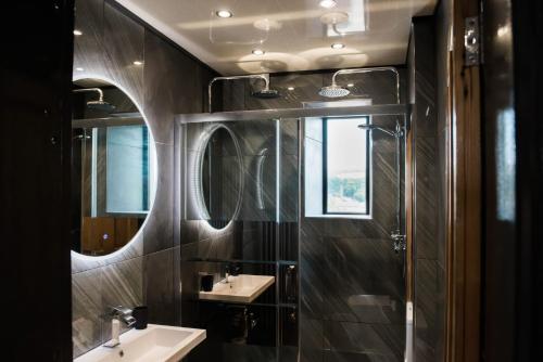 a bathroom with two sinks and a mirror at The Residence in Kendal