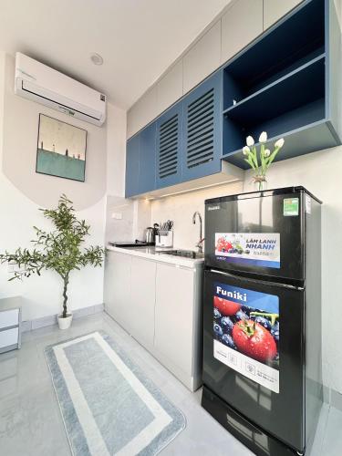 a kitchen with a sink and a refrigerator at The Little Hanoi - Cool Apartment - Lakeside in Hanoi