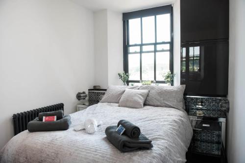 a bedroom with a bed with towels on it at The Residence in Kendal