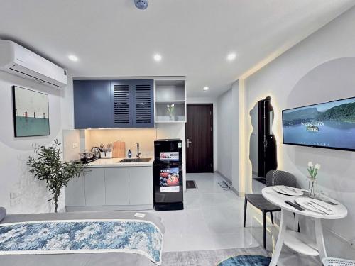 a kitchen and a living room with a sink and a table at The Little Hanoi - Cool Apartment - Lakeside in Hanoi