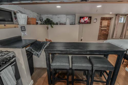 a kitchen with a black table and stools at Wash Park Gem Large Lower Studio Prime Location in Denver