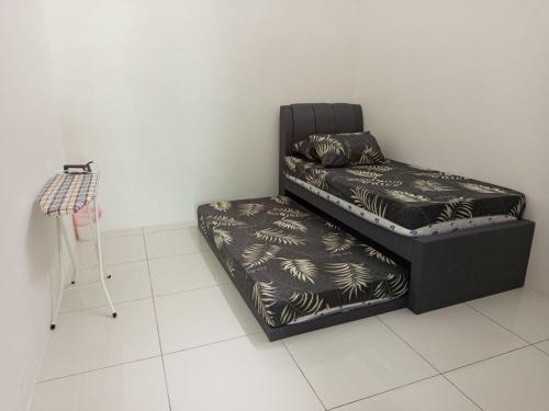 a black chair with a couch in a room at Iman4 Homestay in Kampung Behrang